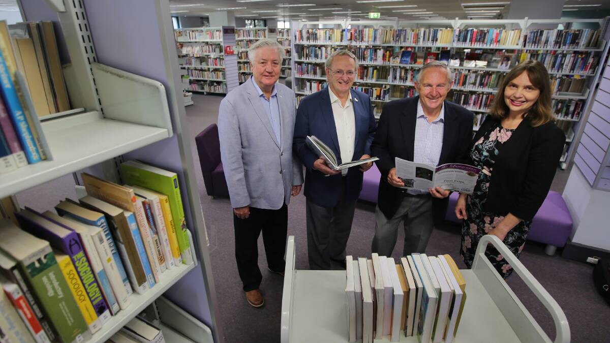 Literary competition launched: Councillors Michael Forshaw (left), Tom Croucher and Barry Collier and Kellie Wilson (community engagement) in Sutherland Shire Library. Picture: John Veage