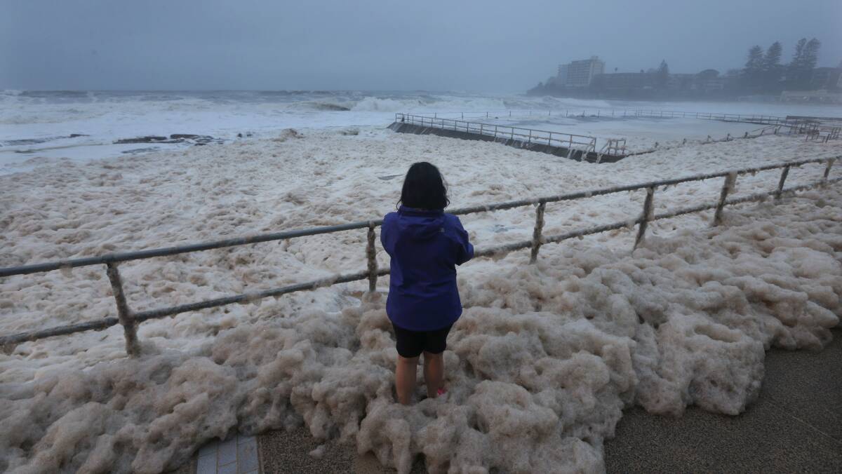 Foam churned up by big seas covered the Esplanade, rock pools and beach on Monday. Picture: John Veage