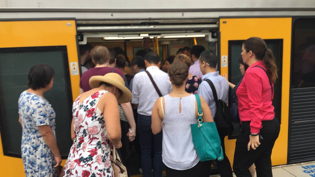 Passengers try to board an overcrowded train at Kogarah.