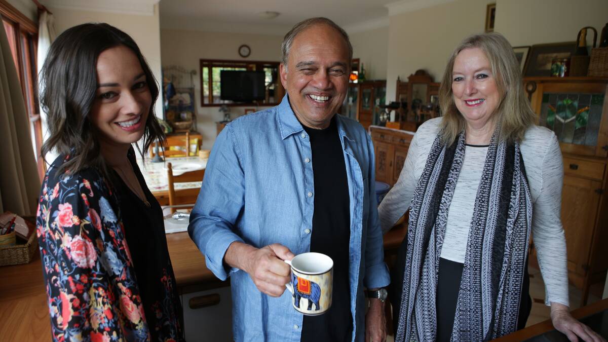 Family relief: Dr Kiran Phadke at home with his wife Linda and daughter Alana after he was cleared to return to St George and Sutherland Hospitals. Picture: John Veage