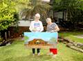 Lee Patterson (left) and Jeanne Pedersen with a painting she did of her family's home Aikito, which was on the site where the petrol station now stands. Picture by Chris Lane