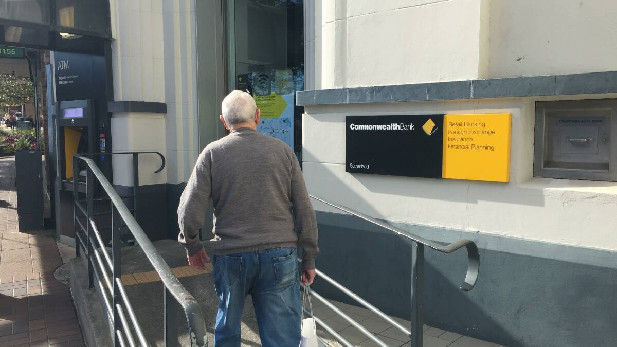 A customer is greeted by the closure sign on the doors of the bank. 