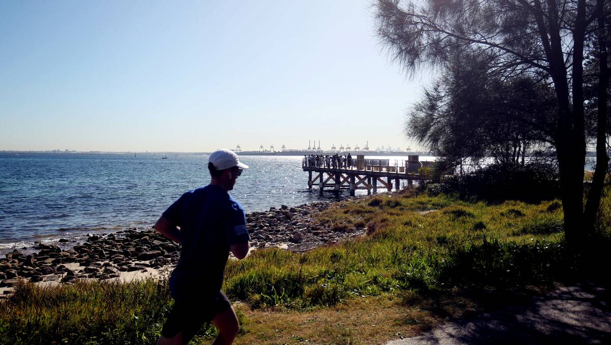 A jogger passes the old wharf at Kurnell. Picture by John Veage