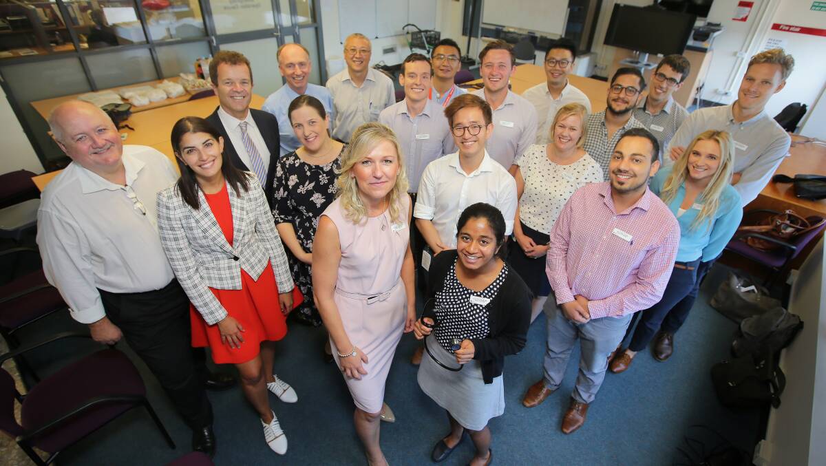Some of the new interns, including Dr Nicole Minto (third row, far right, wearing blue top) with staff and state MPs at Sutherland Hospital. Picture: Chris Lane