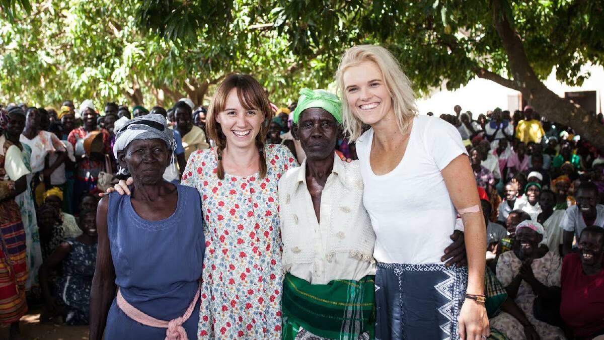 Caitlin Barrett (left), Eloise Wellings with two Ugandan women who are benefiting from the work of the charity. Picture: supplied