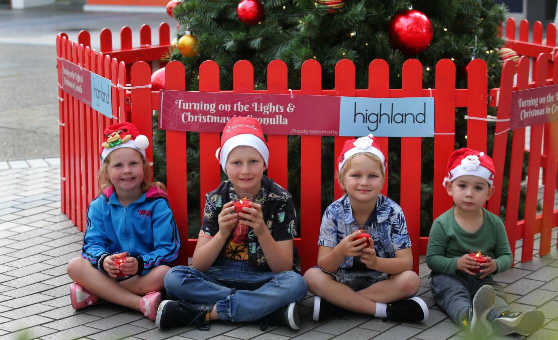 Christmas celebration: Gia, 5, Hamish 8, Gia, Archer, 6, and Marley, 3 next to the Christmas tree in the mall near Ocean Grove. Picture: John Veage 