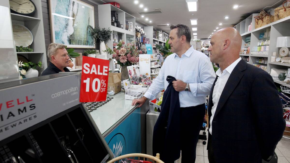 Steve Kamper, with Labor candidate Simon Earle, chats with small business owner Pete McGrath at The Gymea Lily giftware store during the election campaign. Picture by Chris Lane