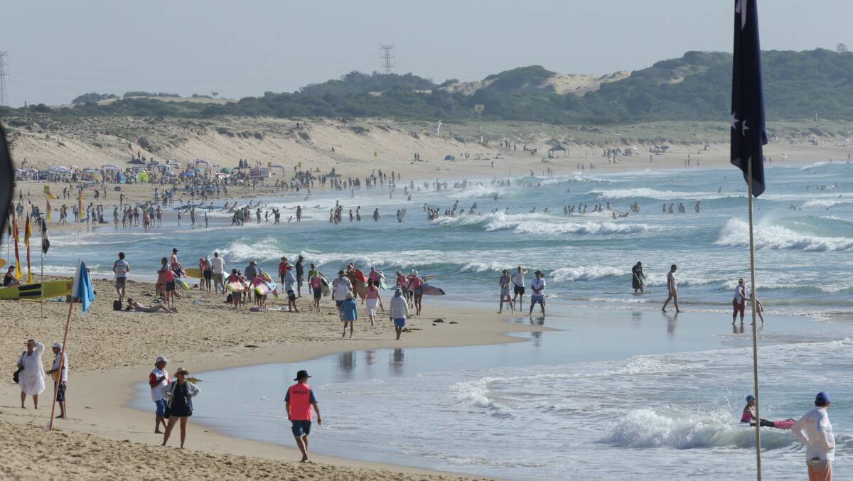 Thousands of people packed Bate Bay beaches over the unofficial four-day weekend. Picture by John Veage