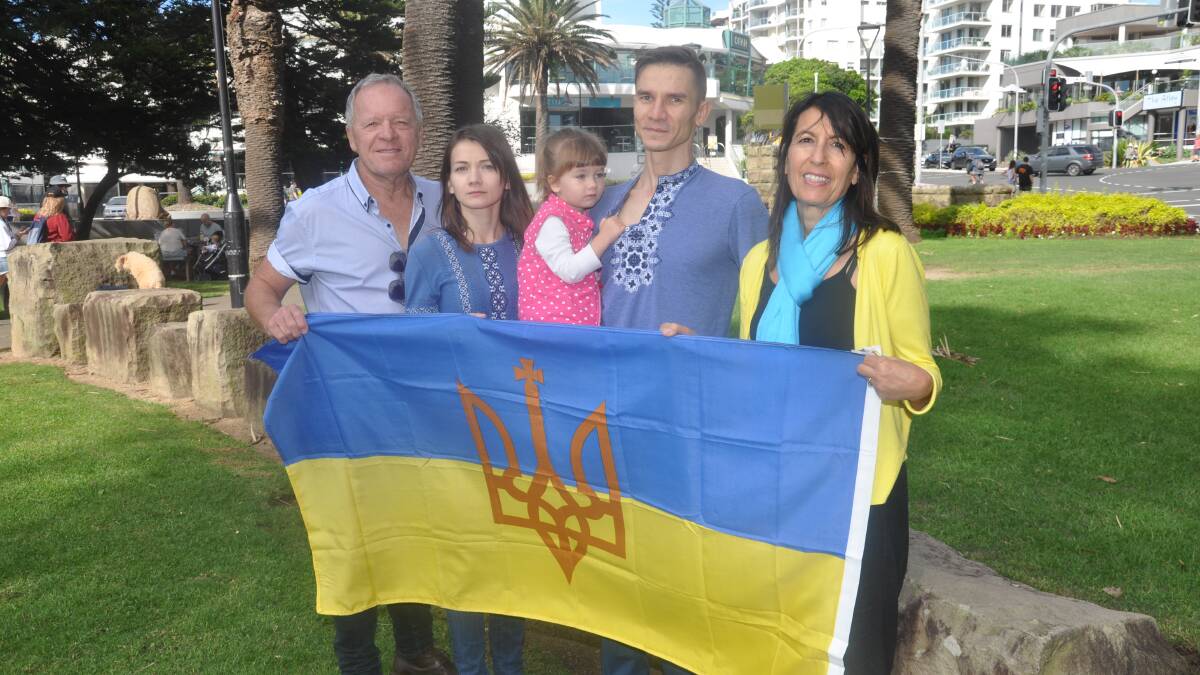 Community committee members Rod Coy and Kathy Totidis with Kateryna and Vasyl Boroviak, who is holding their daughter Hanna, in Dunningham Park, where the event will be held.