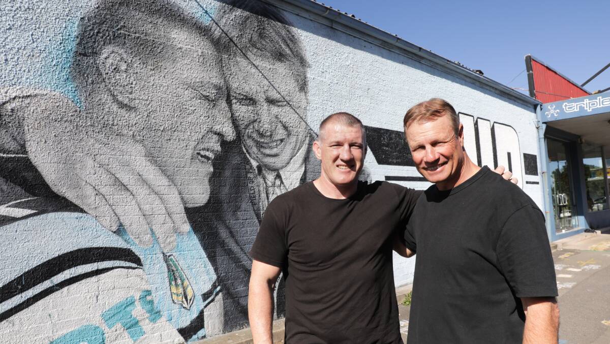 Paul Gallen and Andrew Ettingshausen in front of the mural at Cronulla. Picture by John Veage