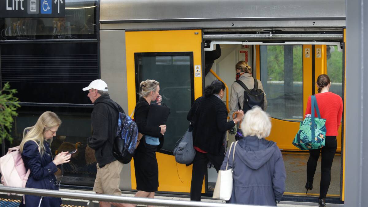 Train travellers at Sutherland go about their business as the coronavirus crisis grows. Transport officials are encouraging off-peak travel where possible. Picture: John Veage