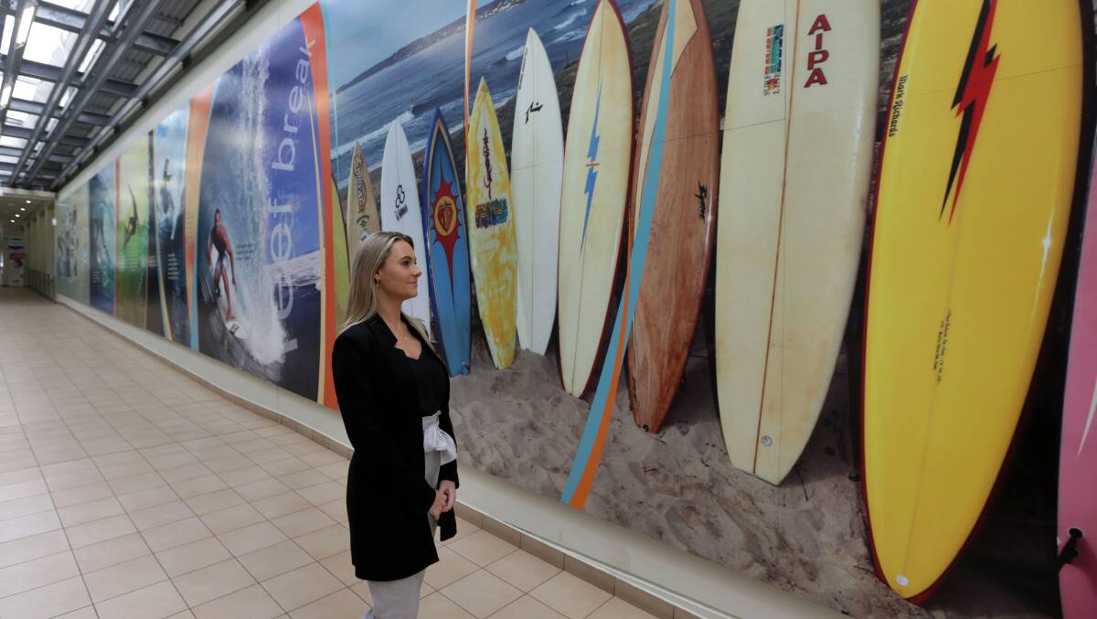 Rich history: Samantha Biddlecombe checks out the display of surfboards from over the years in the surfing gallery in Sutherland Shire Council's Cronulla Central in the mall. Picture: John Veage 