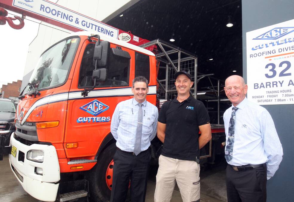 Business weathers storm: Stewart Porter (left), Jared Keen and Don Anderson at the Ace Gutters factory at Mortdale. Picture: Chris Lane