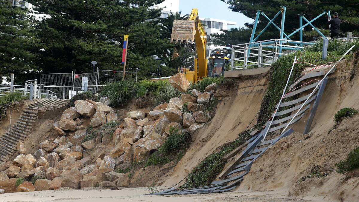 Boulders are placed in position at North Cronulla next to where the lifeguard tower and a former walkway to beach were located. Picture: John Veage