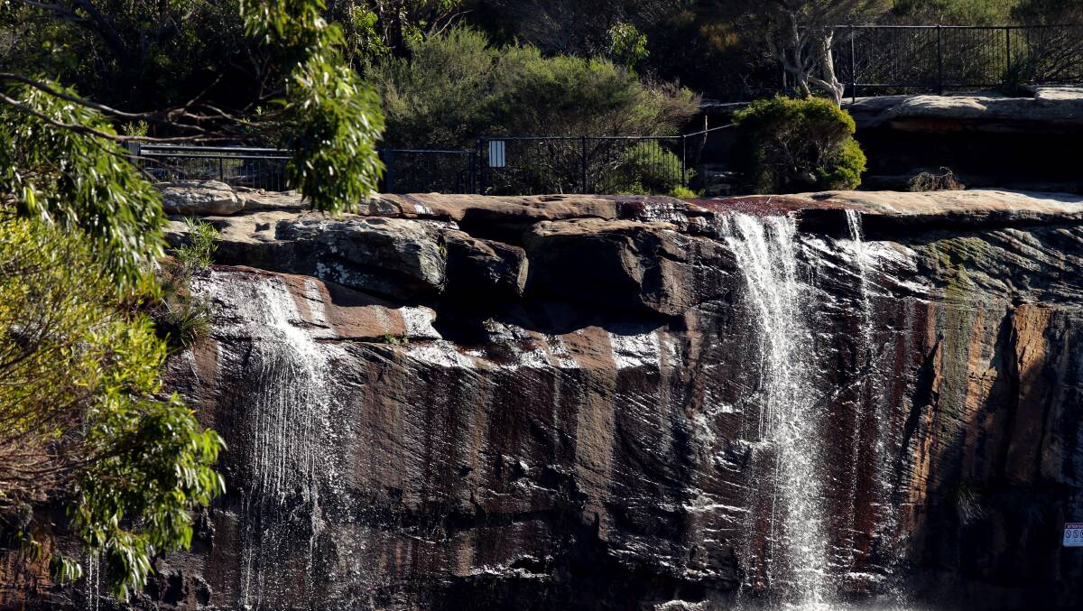 Despite warning signs visitors to Wattamolla continue to risk injury by jumping off the cliffs into the lagoon. Picture: Chris Lane