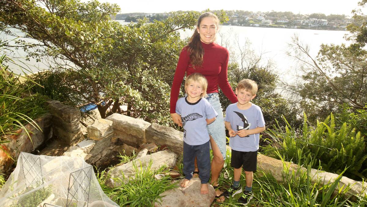 Rachel Melrose, with her sons Reef and Jim, in the bushland around her home at Cronulla. Picture by Chris Lane