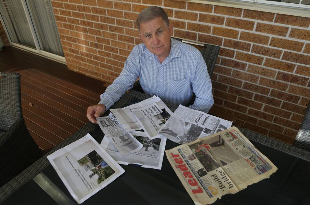 Deja vu: Cr Steve Simpson with copies of Leader reports on the 1980s battle for a new bridge at Woronora, which the community won. Picture: John Veage