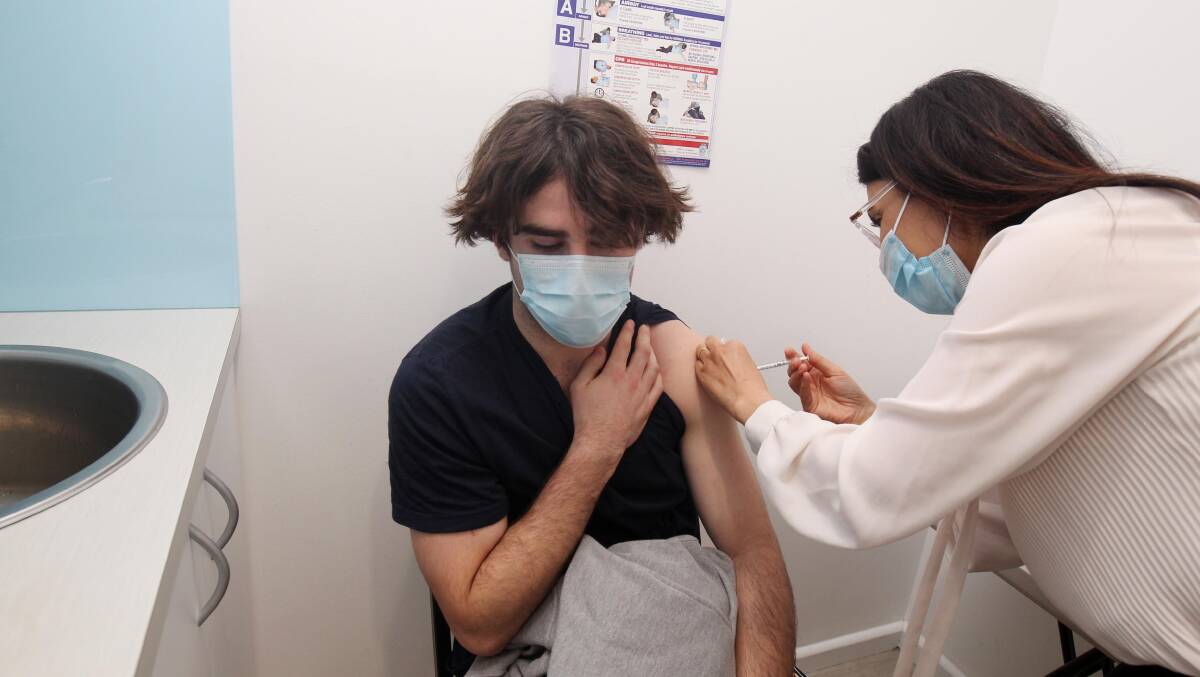 Angus Smith, 19, is vaccinated by Helen Nakhla at Kingsway Night & Day Pharmacy, Woolooware. Picture: Chris Lane
