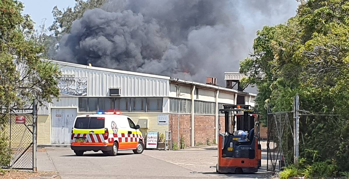 Factory fire: Smoke is seen billowing from the fire in Taren Point.
