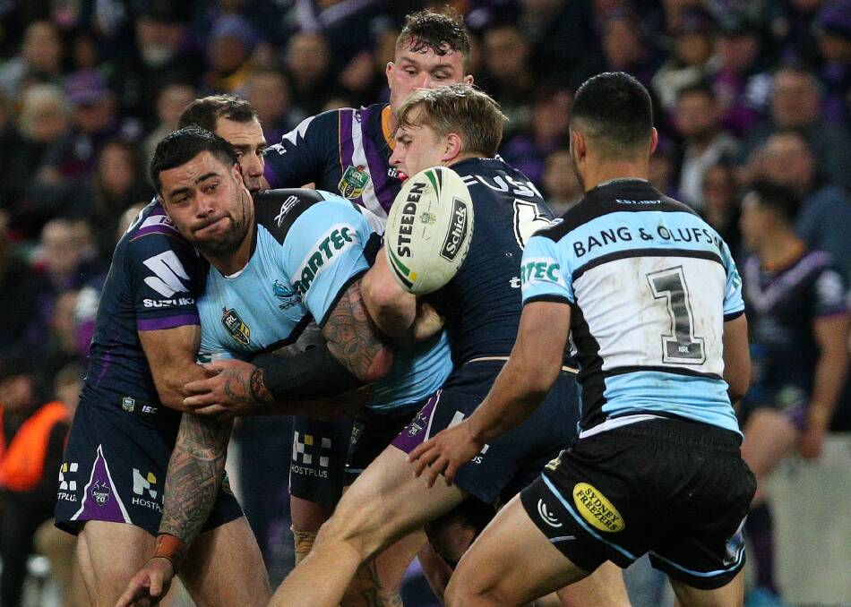 "Passionate": Andrew Fifita offloads to Sharks team mate Valentine Holmes during the Preliminary Final match against the Melbourne Storm at AAMI Park in Melbourne. Picture: AAP Image/Hamish Blair
