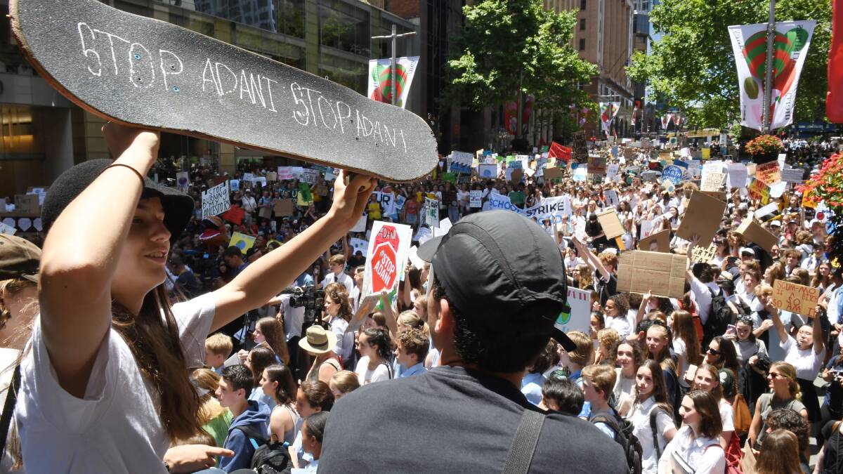 Thousands of students are protesting in Sydney's Martin Place against the government's inaction on climate change. Pictures: Louie Douvis, Nick Moir