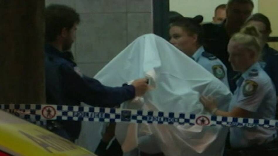 A seven-year-old girl is carried from the Arena Building in Derby Street, Kogarah, following the November 15 assault. Picture: 9News