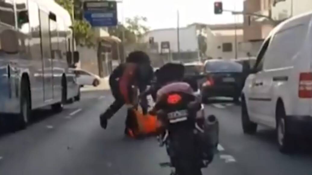 

Road rage: The motorbike rider lashes out with his boots. Picture: 7 News