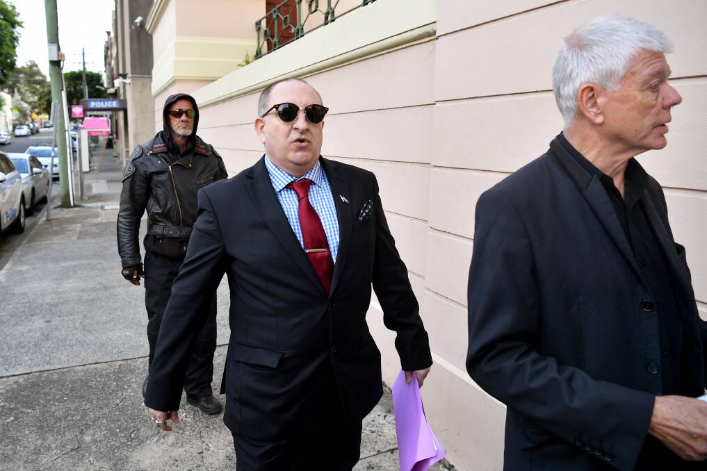 Rightwing extremist Nathan Sykes, centre, outside Newtown Local Court yesterday with Australia First Party chairman Jim Saleam, right, and another supporter. Picture: Sydney Morning Herald