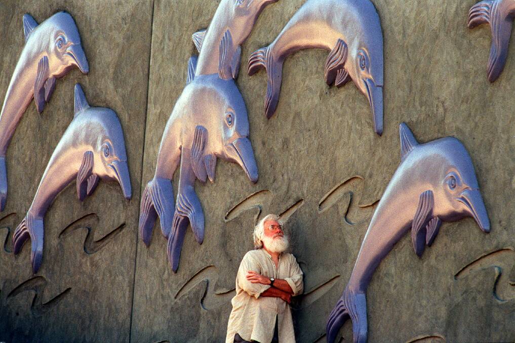 Bob Marchant in 1998 with his wall of dolphins that adorn the sound barriers on the Princes Highway at Sutherland. Picture: Peter Rae