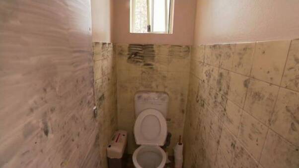 Marks on the toilet cubicle walls show where forensic officers worked in the aftermath of the alleged assault. Picture: 9 News