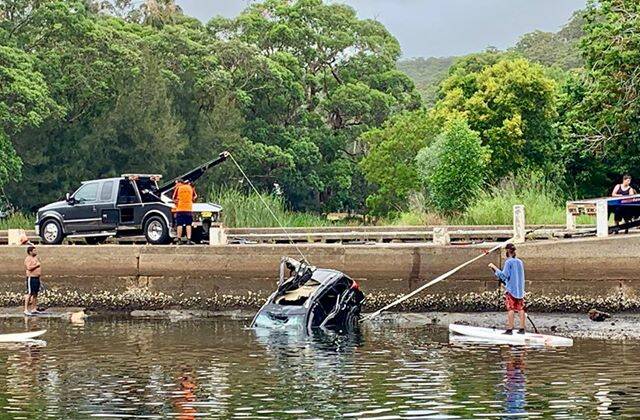 Up, up and away: a car is lifted out of the Hacking River during a salvage operation at Audley Weir on Monday afternoon. Pictures: Rebecca Coram 
