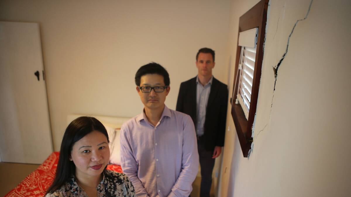 Plea over cracks: Christine and Allen Wong, with Kogarah MP Chris Minns, next to a crack that runs from floor to ceiling.