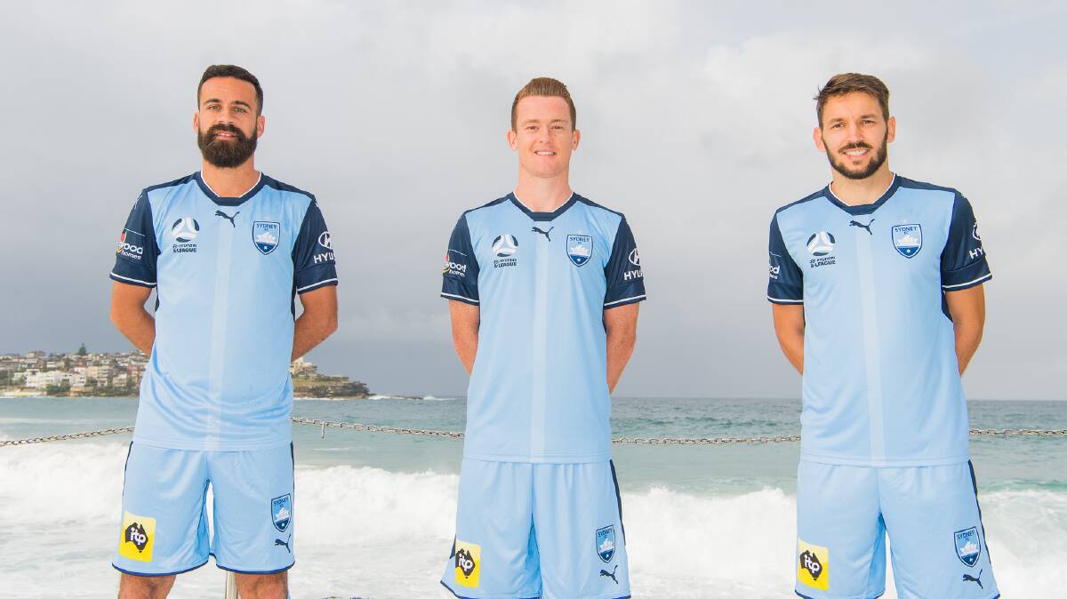Sydney FC captain Alex Brosque, Brandon O'Neill and marquee Milos Ninkovic model the new kit at Bondi.