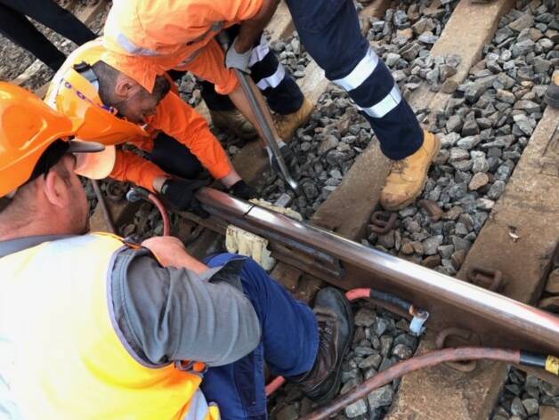 Rail crew work to repair a broken rail at Oatley station. 
