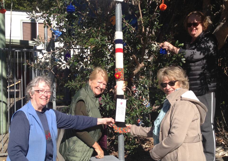 Yarn-bombing: Street signs are decorated in Maianbar for the annual Winter Warmers Festival. From left, Joan Morris, Shirley-Anne Pengly, Lorrie Donaldson and Tracey Curtain.