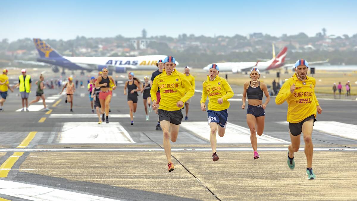 Runners from the Wanda Surf Life Saving Club fly down the tarmac at the Sydney Airport Centenary Runway Run. Pictures: Kurt Ams