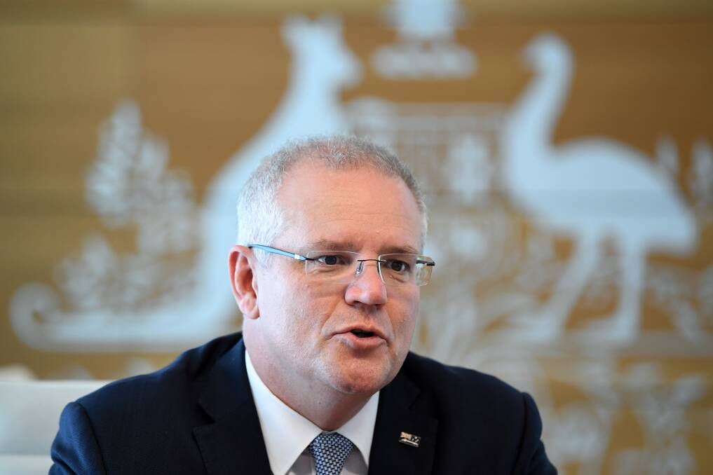 Getting on with the job: Prime Minister Scott Morrison at a meeting at the Commonwealth Parliament Offices in Sydney on Monday. Picture: Joel Carrett, AAP