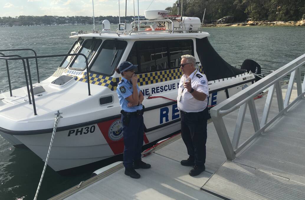 Investigation underway: Sergeant Rebecca Middleton from the NSW Police Force Marine Area Command and Marine Rescue NSW regional operations manager Glenn Evans inspect the vandalised  rescue vessel on Monday. Picture: Supplied