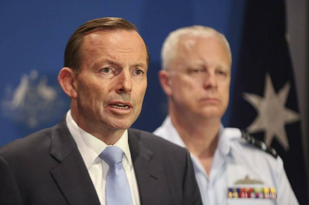 Tony Abbott speaks of Australia's military plans with the Chief of Defence, Air Chief Marshal Mark Binskin, in Darwin on Sunday. Photo: Office of the Prime Minister