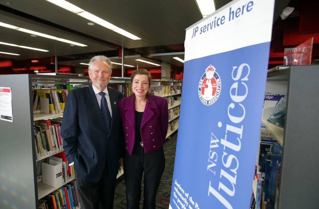 Help desk now open: Justices of the peace Ray Lawson and Filomena Sousa provide free services at Cronulla Library. Picture: Chris Lane