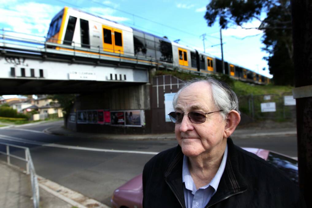 Train watcher: Bob Schroeder in front of the rail bridge near Sutherland Hospital. Picture: John Veage