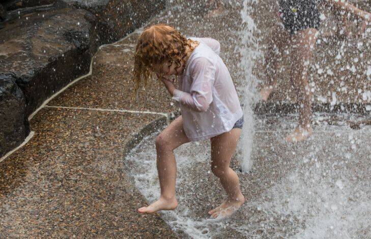 WEATHER: Claudia White (4 yrs) plays in the water area of the recently opened Ian Potter Children??????s Wild Play Garden in Centennial Park, Sydney, where the design emphasis is on kids interacting with the natural enviroment, on 2 January 2018. Photo: Jessica Hromas