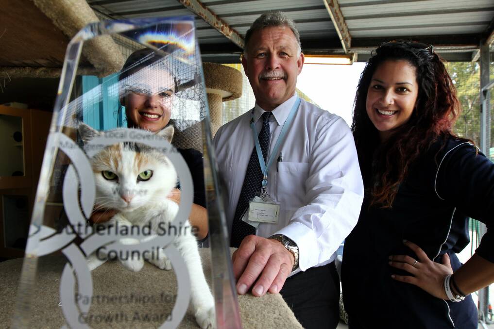 Feline good: Sutherland Shire Council Animal shelter operational manager Jeremy Bennett with Shara Bryant (left ), Katie Bryce and Shoula the cat. The shelter has won a major award. Picture: John Veage