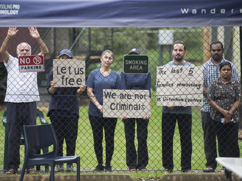 Fifteen refugees detained in a compound at Darwin airport have been left there in limbo for a year.