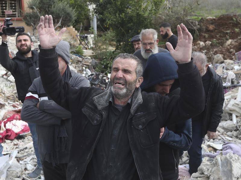 The father of Ibrahim Bazzi, Ahmad Bazzi, mourned them in the rubble of his house. (AP PHOTO)