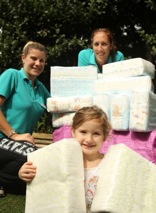 Heeding the call: Giggles Early Learning Centre director (back) with the 1000 nappies collected for The Nappy Collective. She is with staff member Vanessa Holding and Alexis Tilacos. Picture: Chris Lane