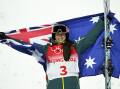 Jakara Anthony holds the Australian flag proudly after her Olympic moguls triumph.