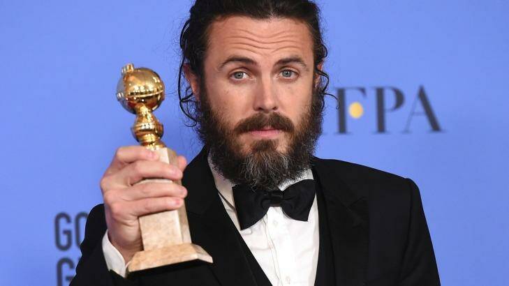 Casey Affleck poses in the press room with the Golden Globe award for his performance in 'Manchester by the Sea'.  Photo: Jordan Strauss