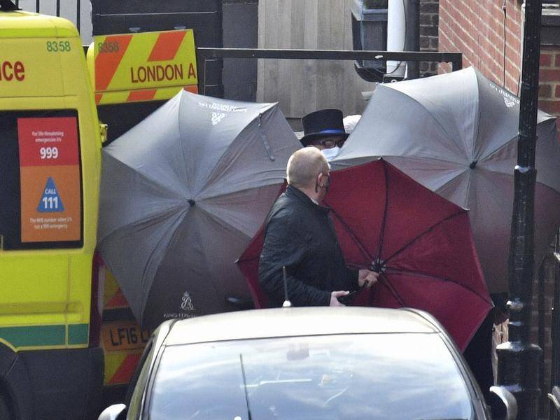 An individual has been shielded from view as they left the hospital treating the Duke of Edinburgh.