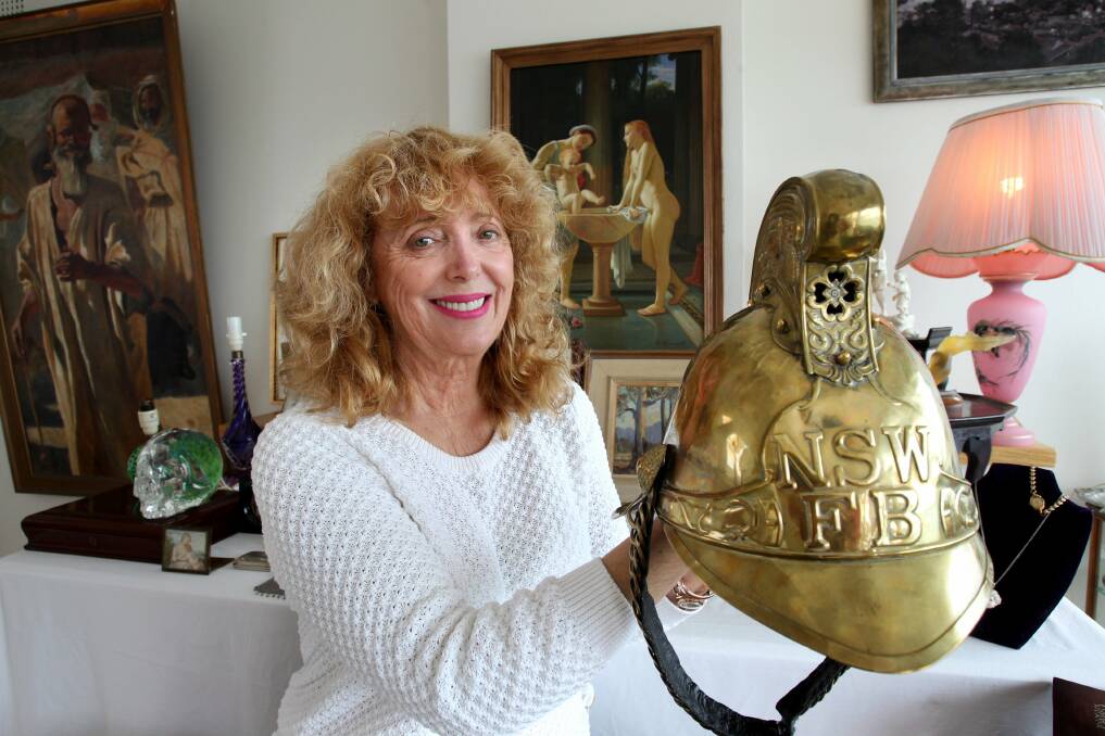 Heads up: Robyn Johannson with a brass fireman's helmet. Picture: Jane Dyson